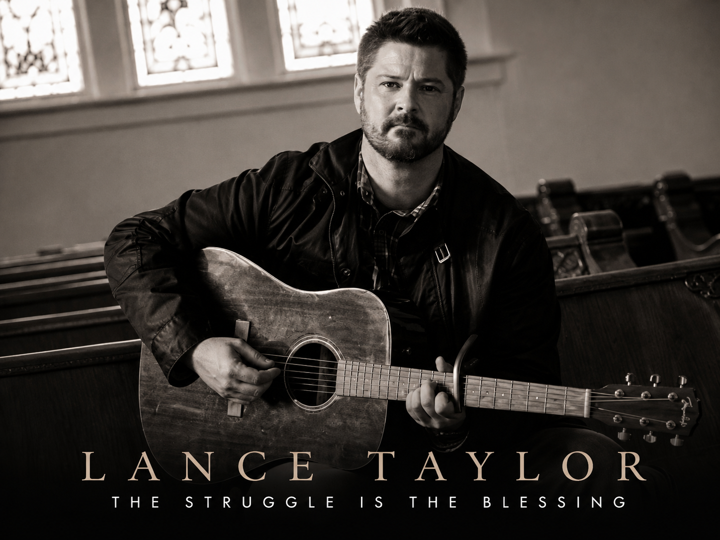 Lance Taylor sitting in a church pew with an acoustic guitar — The Struggle Is The Blessing.